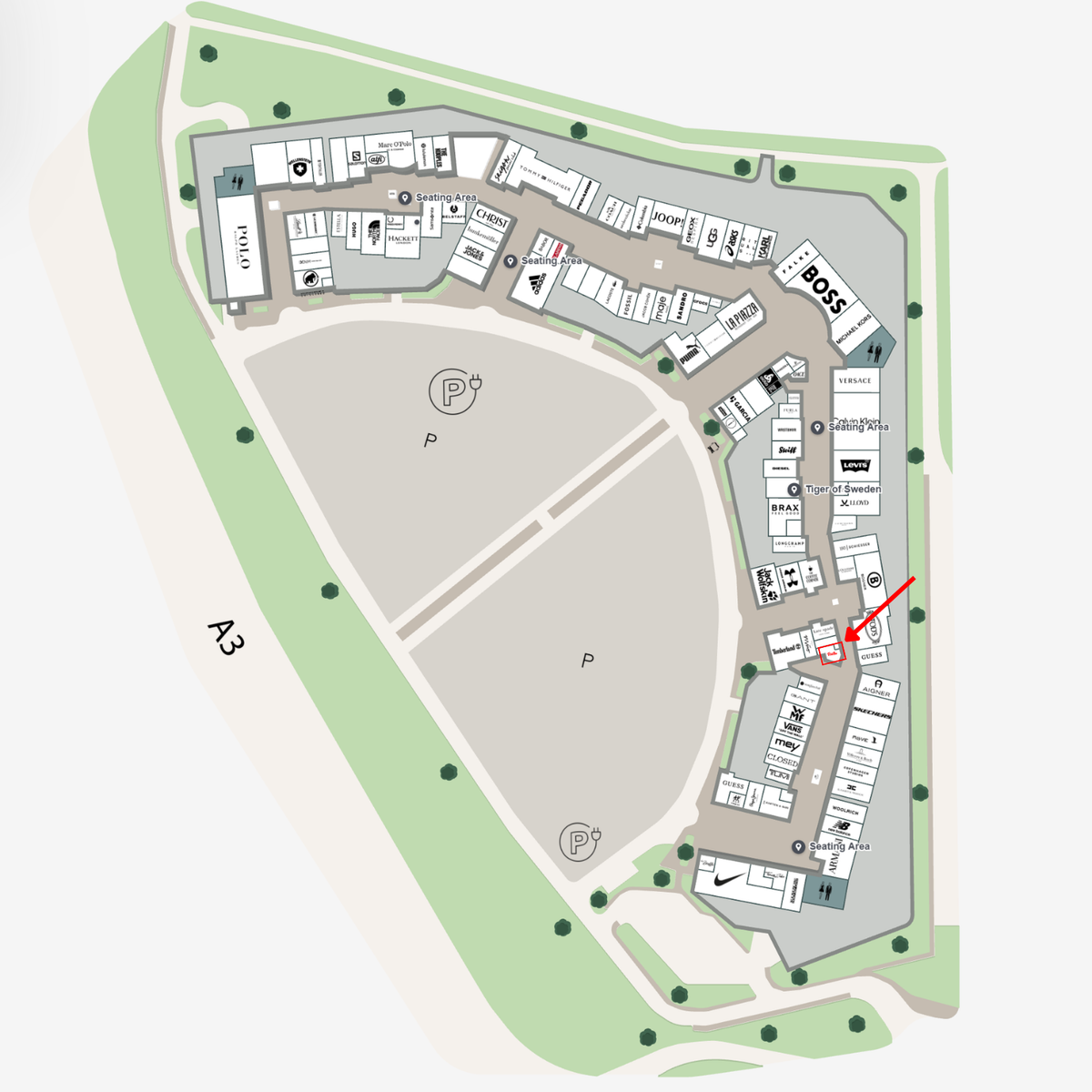 Detailed map of a building complex, clearly showing labeled rooms, pathways, parking zones, and green spaces with signature Fissler precision. A red arrow highlights a specific room in the lower right section—symbolizing the attention to detail and exacting standards found in every Fissler product, from stainless steel pots and pans to innovative pressure cookers and kitchen accessories.